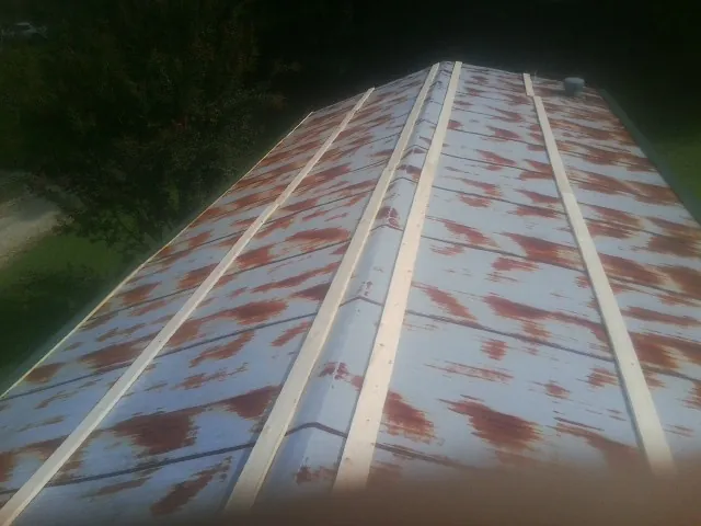 Rusted metal roof panels with new wood purlins before replacement — Storm Damage Roof Repair in Ponce De Leon by Roofing Brothers